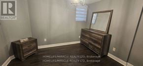 Milton (Ha Harrison) apartment for rent - A room with a wooden dresser and mirror.