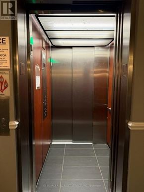 Ottawa condo for rent - A stainless steel elevator with a sign on the left side.
