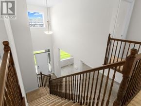 Ottawa apartment for rent - A staircase with a wooden banister leads to a small room with a window.