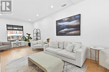 Toronto (High Park-Swansea) apartment for rent - A living room with a grey couch, a coffee table, and a painting on the wall.