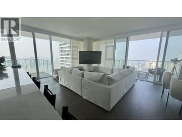Vancouver apartment for rent - A living room with a large couch and a flat screen TV.