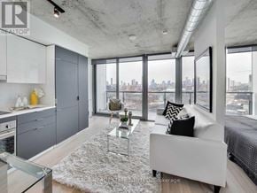 Toronto (Waterfront Communities) condo for rent - A modern living room with a view of the city skyline.