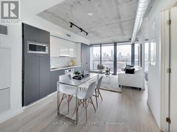 Toronto (Waterfront Communities) condo for rent - A modern kitchen with a dining table and chairs.