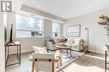 Central Elgin (Port Stanley) multi-family for rent - A living room with a white sofa set and a wooden coffee table.