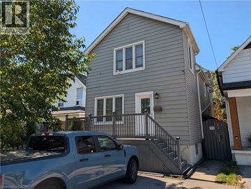 Hamilton apartment for rent - A silver truck is parked in front of a grey house.