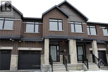 Ottawa townhouse for rent - A two-story brick house with a black front door and windows.