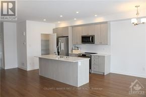 Ottawa townhouse for rent - A modern kitchen with a large island in the middle.