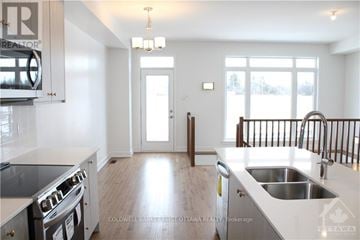 Ottawa townhouse for rent - A modern kitchen with a stove top oven and a sink.