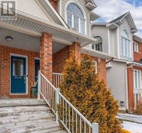 Ottawa condo for rent - A house with a blue door and a white railing.