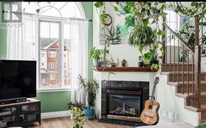 Ottawa condo for rent - A living room with a fireplace and a guitar on the floor.