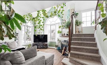 Ottawa condo for rent - A living room with a grey couch and a television.