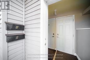Ottawa apartment for rent - A white door is in a room with a white wall and a mailbox.