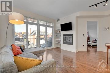 Ottawa condo for rent - A living room with a grey couch and a yellow pillow.