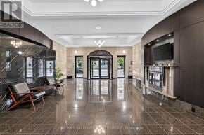 Ottawa condo for rent - A lobby with a marble floor and a large glass wall.