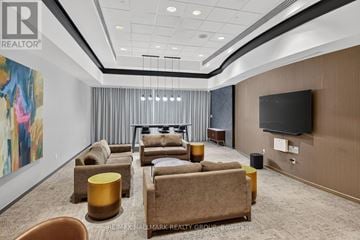 Ottawa condo for rent - A living room with a large painting on the wall and a flat screen TV mounted on the wall.