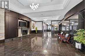 Ottawa condo for rent - A spacious lobby with a fireplace and seating area.