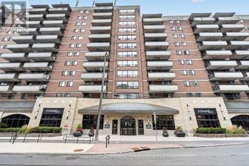 Ottawa condo for rent - A tall apartment building with a Doneness storefront at the base.