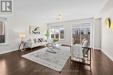 Ottawa townhouse for rent - A well-lit living room with a grey rug and a white sofa.