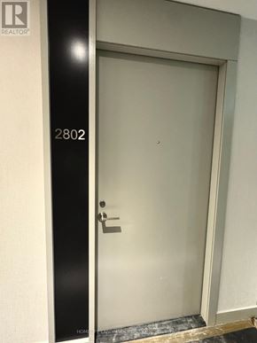Toronto (Waterfront Communities) condo for rent - A door with a handle and a number 2802 on the wall.