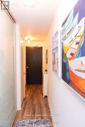 Toronto (Trinity-Bellwoods) condo for rent - A hallway with a painting of a boat on the wall.