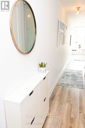 Toronto (Trinity-Bellwoods) condo for rent - A white cabinet with a round mirror above it.