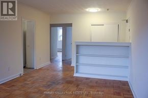 Toronto (Englemount-Lawrence) multi-family for rent - A room with wooden flooring and white walls.