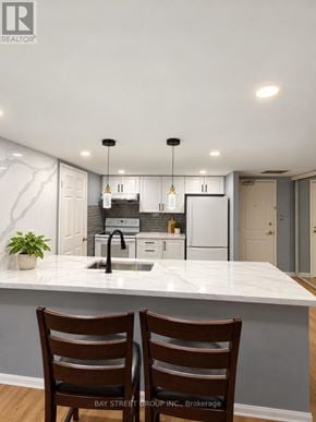 Toronto (Niagara) condo for rent - A kitchen with a marble countertop and two wooden chairs.