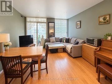 Toronto (Niagara) condo for rent - A living room with a grey couch and wooden furniture.