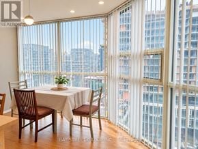 Toronto (Niagara) condo for rent - A dining room with a table set for two with a view of the city.