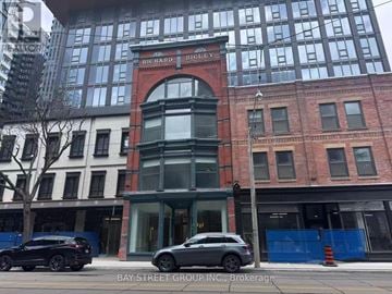 Toronto (Church-Yonge Corridor) condo for rent - A car is parked in front of a building with a sign that says "Bay Street Group Inc.".