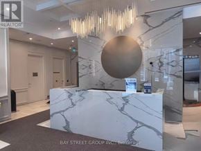 Toronto (Church-Yonge Corridor) condo for rent - A reception area with a marble counter and a chandelier.