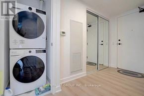 Toronto (Church-Yonge Corridor) condo for rent - A white washing machine is in a room with a white door and a white wall.