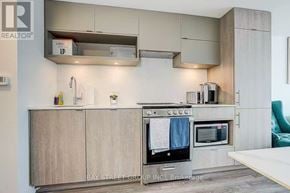 Toronto (Church-Yonge Corridor) condo for rent - A modern kitchen with a stove top oven and microwave.