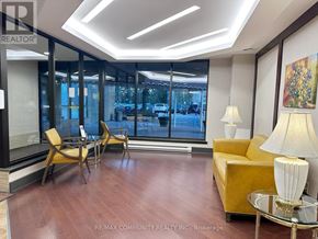 Toronto (Steeles) condo for rent - A well-lit room with a yellow sofa and a glass table.
