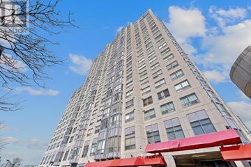 Toronto (Dorset Park) condo for rent - A tall building with a red awning at the entrance.