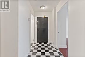 Toronto (Dorset Park) condo for rent - A hallway with a black and white checkered floor.