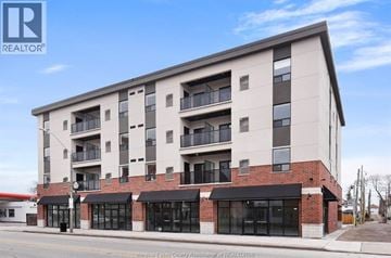 Windsor apartment for rent - A modern apartment building with a brick facade and multiple balconies.