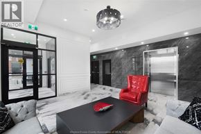 Windsor apartment for rent - A black and white photo of a room with a red chair and a table.