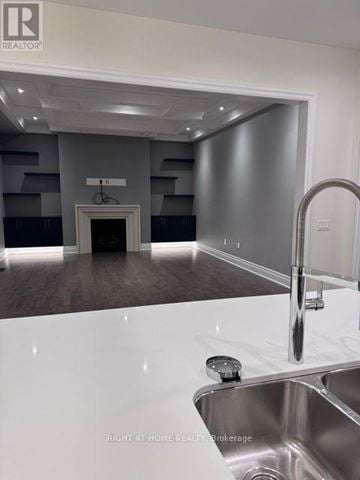Vaughan (Patterson) apartment for rent - A modern kitchen with a stainless steel sink and a white countertop.
