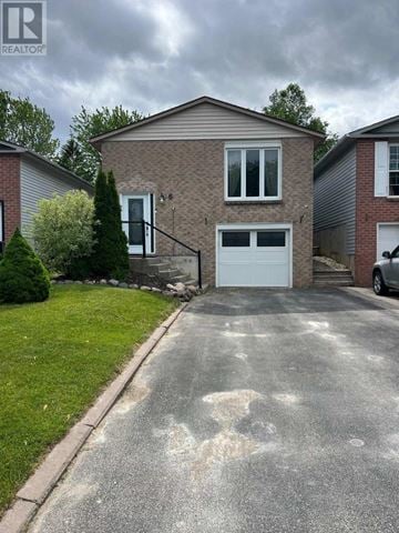 Bradford West Gwillimbury (Bradford) apartment for rent - A house with a grey garage door and a driveway in front.