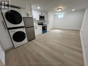 Bradford West Gwillimbury (Bradford) apartment for rent - A laundry room with a washer and dryer stacked on top of each other.