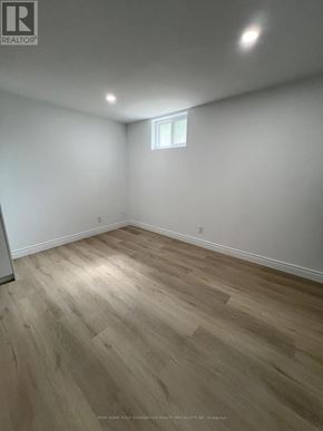 Bradford West Gwillimbury (Bradford) apartment for rent - A room with wooden flooring and a window.