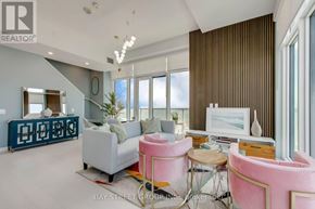 Mississauga (City Centre) house for rent - A living room with a pink chair and a white couch.