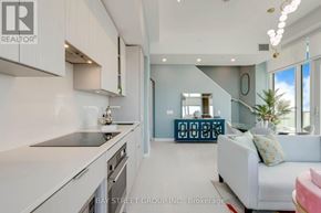 Mississauga (City Centre) house for rent - A modern kitchen with white cabinets and a large island.