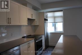 Mississauga (Lakeview) townhouse for rent - A kitchen with a stove top oven and a dishwasher.