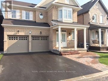 Brampton (Credit Valley) apartment for rent - A large, two-story house with a brick facade and a large front yard.