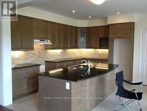 Brampton (Credit Valley) apartment for rent - A kitchen with wooden cabinets and a black countertop.