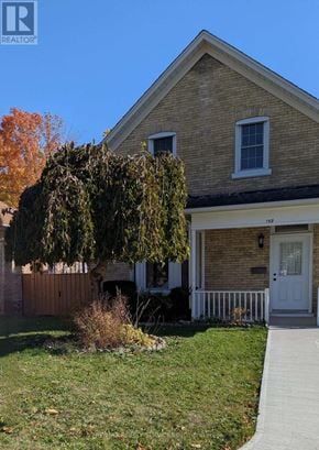 Cambridge apartment for rent - A house with a white door and a small front yard.