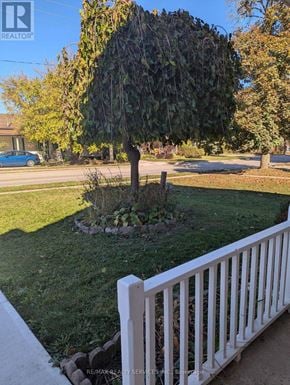Cambridge apartment for rent - A white picket fence surrounds a tree in a yard.