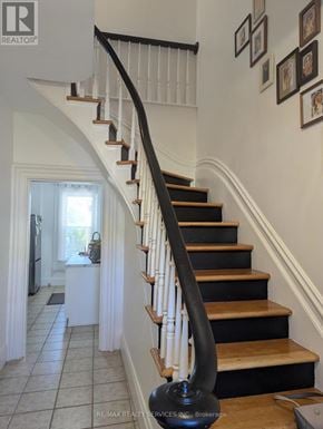 Cambridge apartment for rent - A staircase with a black railing and wooden steps.